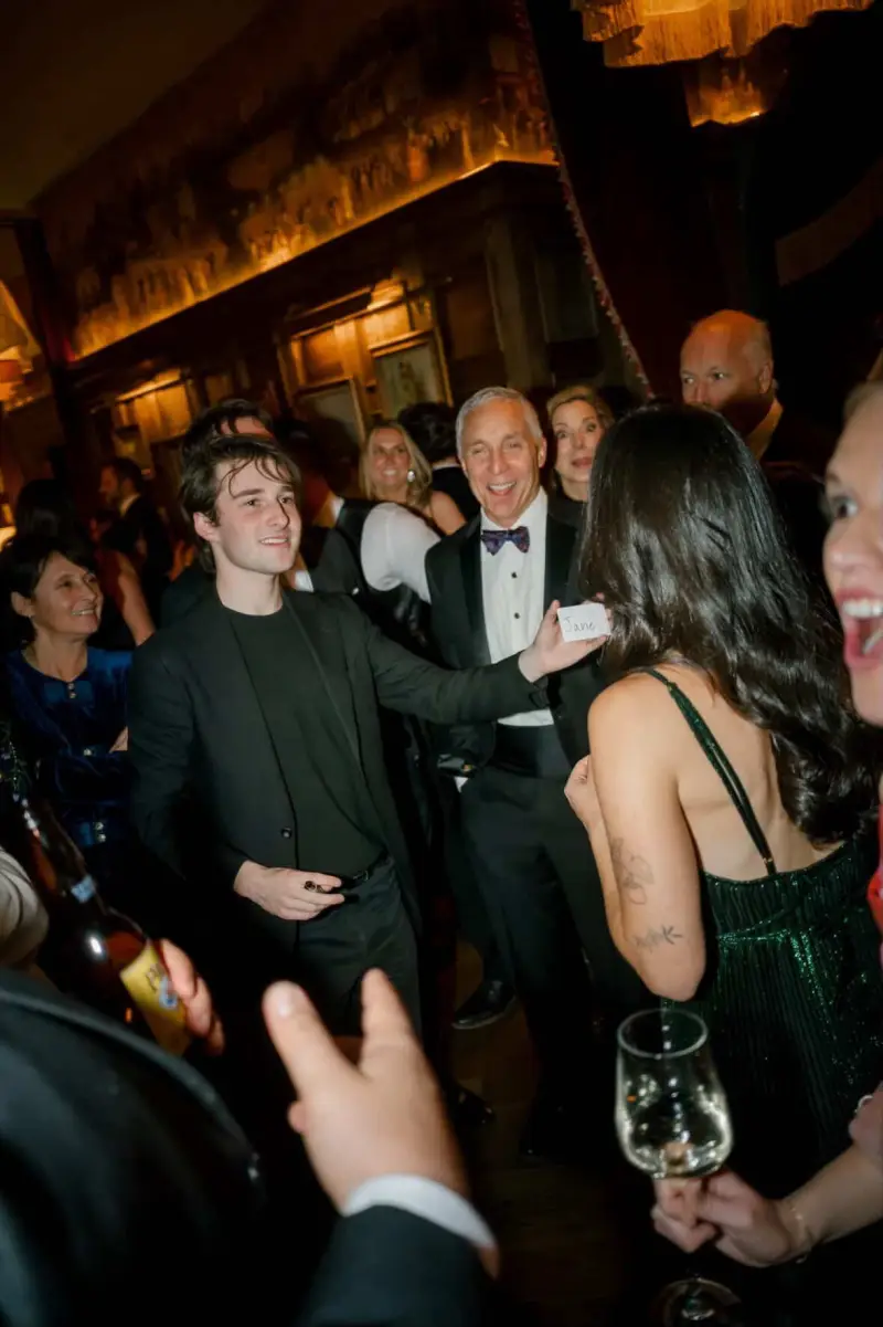 Jacob performing for guests in black tie at an elegant gala