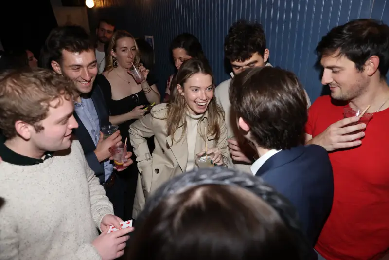 A group of friends smiling during a strolling magic set